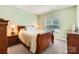 Bedroom features carpet floors, a window bringing in natural light, and matching furniture at 18732 Coachmans Trce, Cornelius, NC 28031