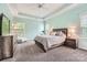 Spacious bedroom features a large bed, dresser, and multiple windows that bring in natural light at 18732 Coachmans Trce, Cornelius, NC 28031