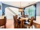 Inviting dining area with natural light, hardwood floors, and an open view of the staircase at 18732 Coachmans Trce, Cornelius, NC 28031