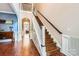 Elegant foyer with hardwood floors, staircase, and wainscoting, creating a grand entrance at 18732 Coachmans Trce, Cornelius, NC 28031