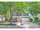 Charming two-story home with green siding, wood accents, and a well-maintained front yard at 18732 Coachmans Trce, Cornelius, NC 28031