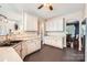 Well-lit kitchen features white cabinets, black appliances, and an open doorway to the dining room at 18732 Coachmans Trce, Cornelius, NC 28031