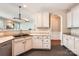 Well-lit kitchen features white cabinets, black appliances, and an open doorway to the living room at 18732 Coachmans Trce, Cornelius, NC 28031