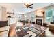 Open living space with fireplace, hardwood floors, and seamless flow to the kitchen and dining area at 18732 Coachmans Trce, Cornelius, NC 28031