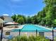 Community pool surrounded by lounge chairs and greenery, perfect for relaxation and recreation at 18732 Coachmans Trce, Cornelius, NC 28031