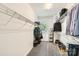 Functional walk-in closet with metal shelving, hanging racks, carpeted floors, and natural light at 18732 Coachmans Trce, Cornelius, NC 28031