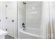 Tiled tub and shower combination with white subway tile and matte black hardware at 2116 Eastway Dr, Charlotte, NC 28205