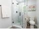 Bathroom with a glass enclosed shower, white marble tile and a modern sink at 2116 Eastway Dr, Charlotte, NC 28205