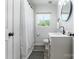 Bathroom features a shower/tub, white vanity and a neutral-toned rug at 2116 Eastway Dr, Charlotte, NC 28205