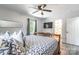 Bedroom with a ceiling fan, tv, and natural light. Bathroom located just off the primary bedroom at 2116 Eastway Dr, Charlotte, NC 28205