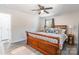 Bedroom features a large bed with decorative pillows, ceiling fan and light gray flooring at 2116 Eastway Dr, Charlotte, NC 28205