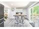 Dining area features a dark wood table, four chairs, and sliding door access to the deck at 2116 Eastway Dr, Charlotte, NC 28205