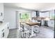 Charming dining area with luxury vinyl plank flooring and view to kitchen and outdoor deck at 2116 Eastway Dr, Charlotte, NC 28205