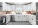 Renovated kitchen features white cabinets, stainless steel appliances, and luxury vinyl plank flooring at 2116 Eastway Dr, Charlotte, NC 28205