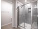 Glass-enclosed shower with gray tile surround in modern bathroom at 2116 Morgan Hills Dr, Albemarle, NC 28001