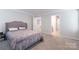 Spacious bedroom features plush carpet, neutral walls, and tufted upholstered headboard at 2116 Morgan Hills Dr, Albemarle, NC 28001