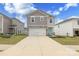 Charming two-story home with stone accents, attached garage, and a welcoming turquoise front door at 2116 Morgan Hills Dr, Albemarle, NC 28001