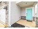 Stylish front entrance featuring a turquoise door, stone accents, and gray siding at 2116 Morgan Hills Dr, Albemarle, NC 28001