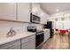 Well-equipped kitchen featuring light gray cabinets, stainless steel appliances, and quartz countertops at 2116 Morgan Hills Dr, Albemarle, NC 28001
