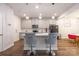 Modern kitchen island with bar seating, light gray cabinets, and stainless steel appliances at 2116 Morgan Hills Dr, Albemarle, NC 28001