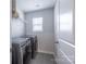 Well-lit laundry room featuring modern appliances and a convenient wire shelf at 2116 Morgan Hills Dr, Albemarle, NC 28001