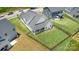 Aerial view of a well-maintained home with a fenced backyard and manicured lawn in a neighborhood at 218 Tetcott St, Mooresville, NC 28115