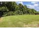 Large, green backyard features a black fence, offering a private and serene outdoor space at 218 Tetcott St, Mooresville, NC 28115