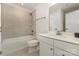 Bathroom with a single sink, large mirror, and tiled shower/tub at 218 Tetcott St, Mooresville, NC 28115