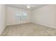 Neutral bedroom featuring carpet, base trim, ceiling fan, and windows with blinds at 218 Tetcott St, Mooresville, NC 28115
