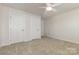 Neutral bedroom featuring carpet and two doors with white trim and hardware at 218 Tetcott St, Mooresville, NC 28115