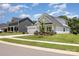 Single-Gathering home with a two-car garage, manicured lawn, and welcoming front porch on a sunny day at 218 Tetcott St, Mooresville, NC 28115
