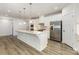 Bright, open kitchen with a large island, stainless steel appliances, and sleek wooden flooring at 218 Tetcott St, Mooresville, NC 28115