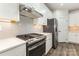 Modern kitchen with stainless steel appliances, white cabinets, subway tile backsplash, and gas range at 218 Tetcott St, Mooresville, NC 28115