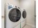 This laundry room includes a GE washer and dryer at 218 Tetcott St, Mooresville, NC 28115