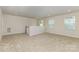 Upstairs loft featuring neutral carpeting, windows, and stairwell at 218 Tetcott St, Mooresville, NC 28115