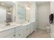 Beautiful main bathroom features dual sinks, white cabinets, and a glass shower with tiled surround at 218 Tetcott St, Mooresville, NC 28115