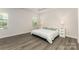 Bright main bedroom with a king bed, neutral paint, tray ceiling, and natural light from windows at 218 Tetcott St, Mooresville, NC 28115