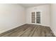 This office features wood flooring and glass french doors at 218 Tetcott St, Mooresville, NC 28115