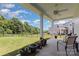 Covered patio with ceiling fan overlooks the fenced backyard, offering a relaxing outdoor space at 218 Tetcott St, Mooresville, NC 28115