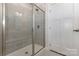 Modern shower features tiled surround, glass doors, a shower seat and modern fixtures at 218 Tetcott St, Mooresville, NC 28115