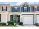 Charming townhouse with blue siding, a one-car garage, and a cozy front porch entrance at 237 River Clay Rd, Fort Mill, SC 29708