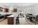 Well-lit kitchen with granite countertops, barstool seating, stainless appliances, and access to the patio at 237 River Clay Rd, Fort Mill, SC 29708