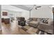 Bright living room featuring hardwood floors, a ceiling fan, and an open layout to the dining area at 237 River Clay Rd, Fort Mill, SC 29708