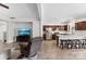 Open concept space with hardwood floors, TV area, kitchen island, and stainless steel appliances at 237 River Clay Rd, Fort Mill, SC 29708