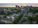 An aerial view of a neighborhood with the city skyline in the background at sunset at 2514 Marshall Pl, Charlotte, NC 28203