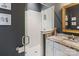Stylish bathroom showcasing white subway tile shower, dark walls, granite countertop and hexagon tile floor at 2514 Marshall Pl, Charlotte, NC 28203