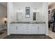A sleek bathroom boasts double sinks, granite countertops, wood-look floors, and a walk-in closet at 2514 Marshall Pl, Charlotte, NC 28203