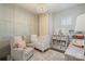 Charming Bedroom featuring soft colors, paneled walls, a comfortable chair, and organized storage shelves at 2514 Marshall Pl, Charlotte, NC 28203