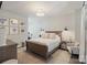 Bright bedroom featuring a neutral color palette, wood furniture, unique art, and a decorative rug at 2514 Marshall Pl, Charlotte, NC 28203