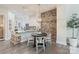 Eat-in kitchen showcases white cabinets, granite countertops, brick accent wall and modern light fixture at 2514 Marshall Pl, Charlotte, NC 28203